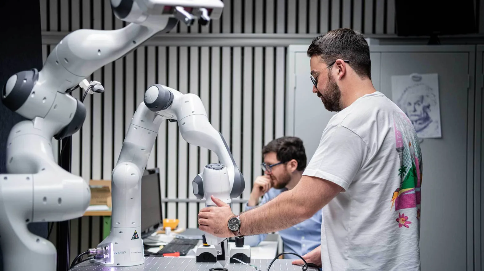 Two men working with robotics