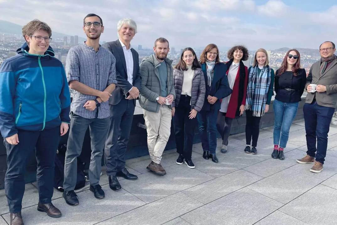 Group photo of ten people on a roof terrace