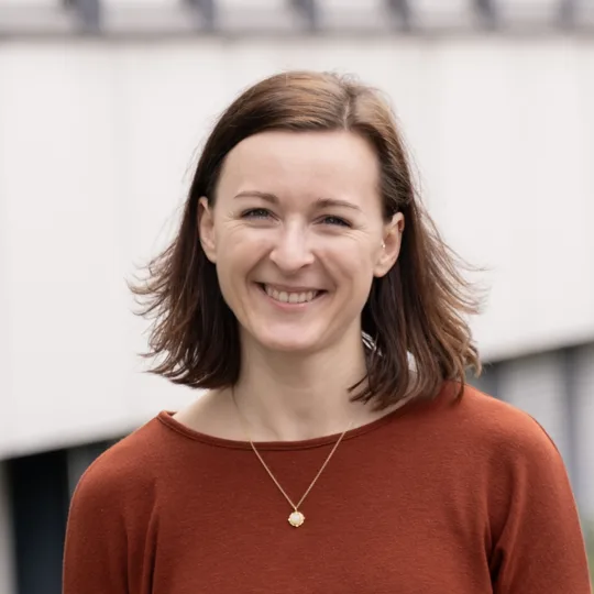 Portrait of a woman in an orange-brown sweater