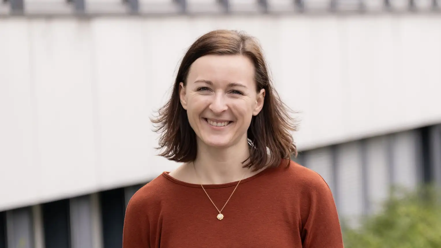 Portrait of a woman in an orange-brown sweater