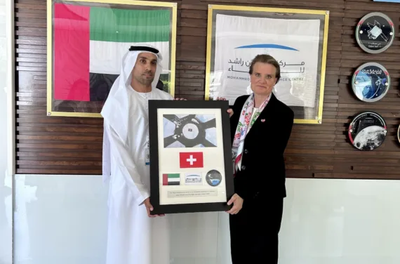 Bild 8 Treffen bei Mohammed Bin Rashid Space Center Un homme et une femme tiennent un cadre dans lequel on peut voir les drapeaux suisse et saoudien.