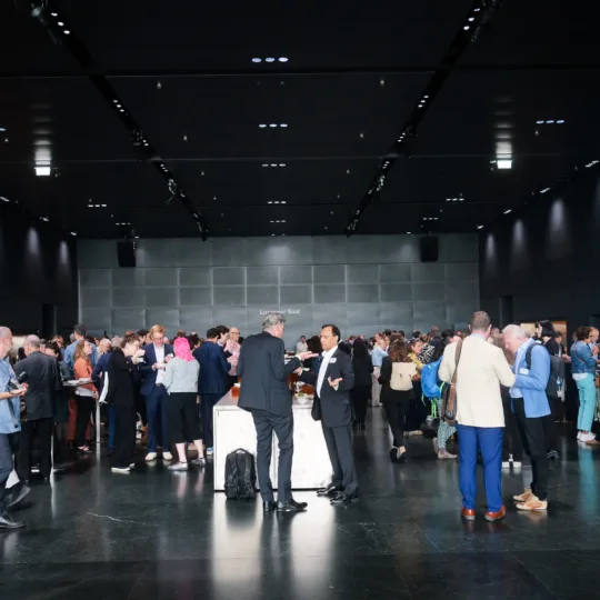 A crowd of people gathered in a large hall.