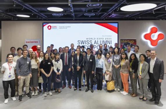 A group of people standing in front of the Swissnex logo.