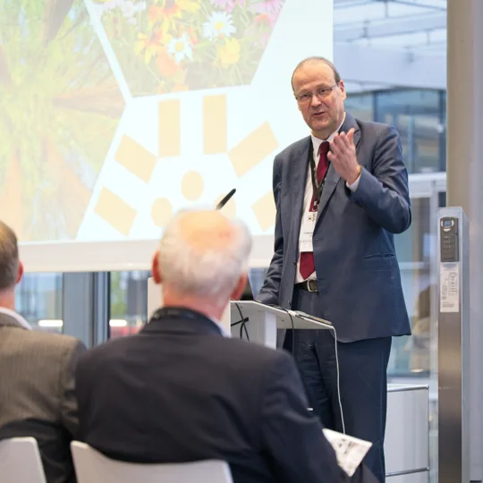 A man speaks in front of an audience