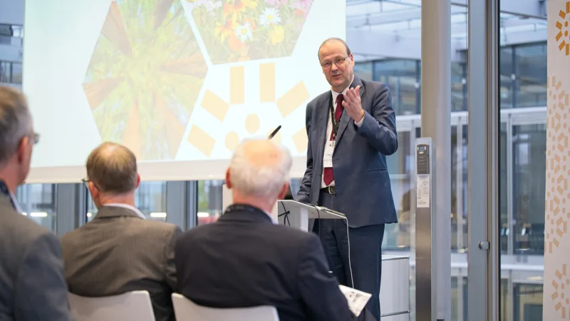 A man speaks in front of an audience
