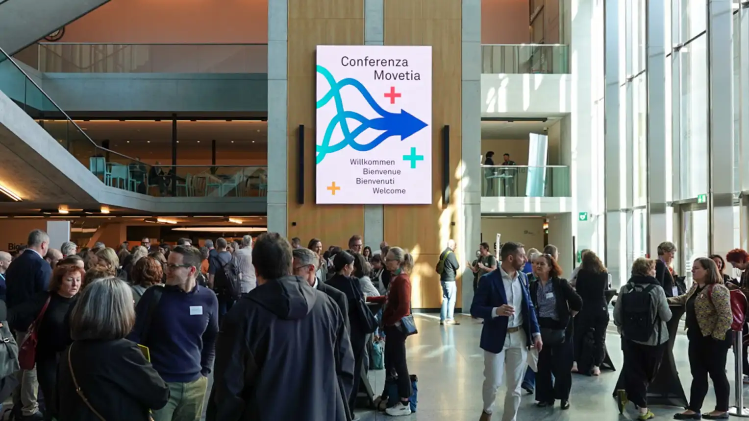 Eine Ansammlung von Menschen in einem grossen Eingangsbereich.