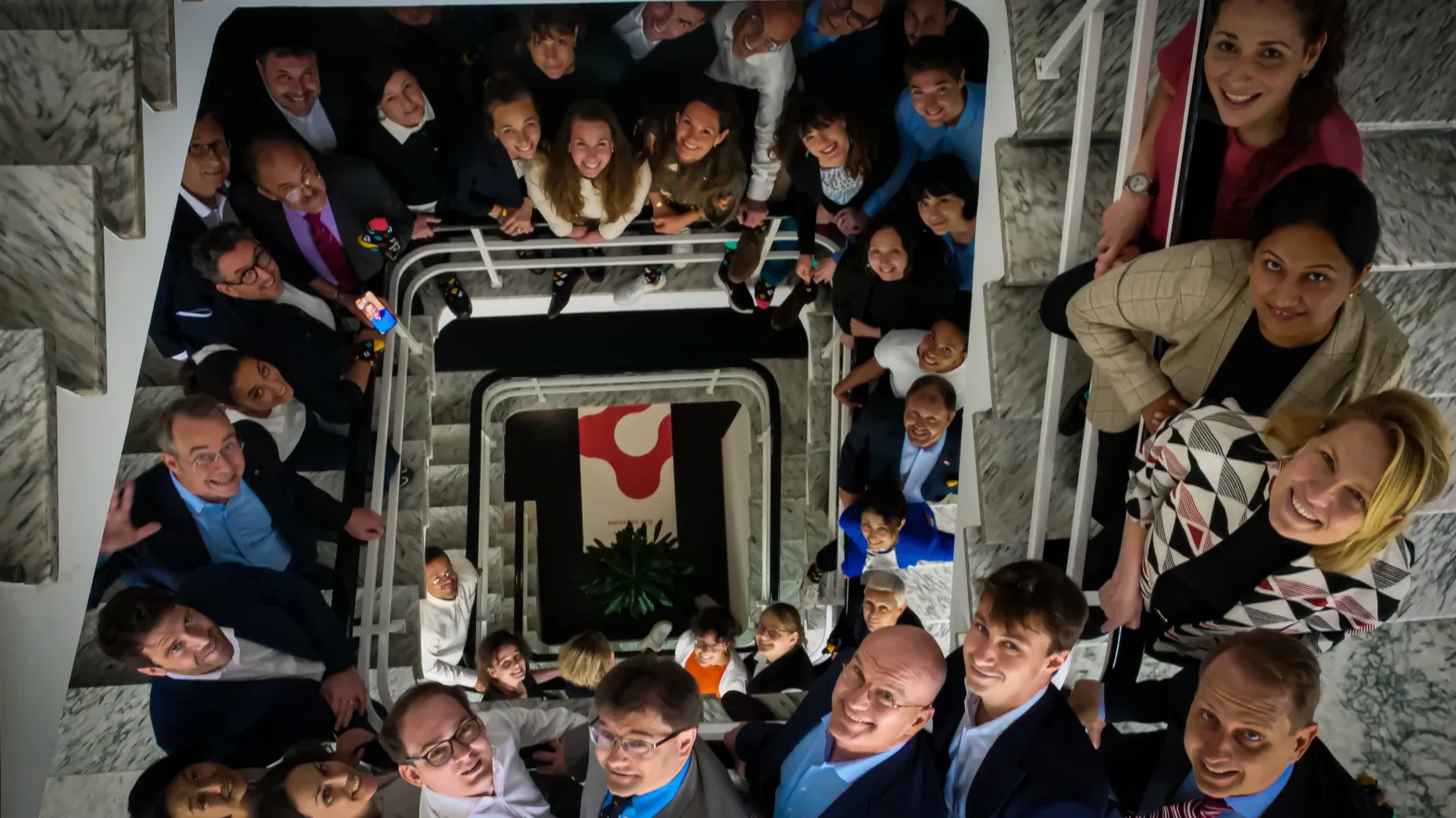 A group photo in a stairwell.